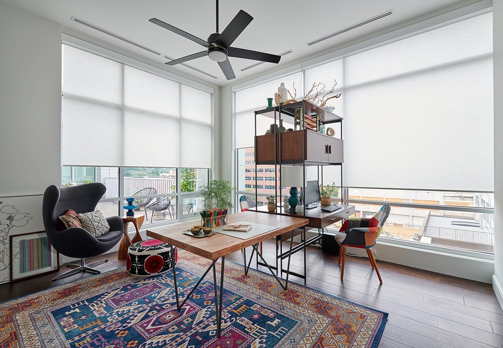Roller Shades filtering in light into a nice home office space. 